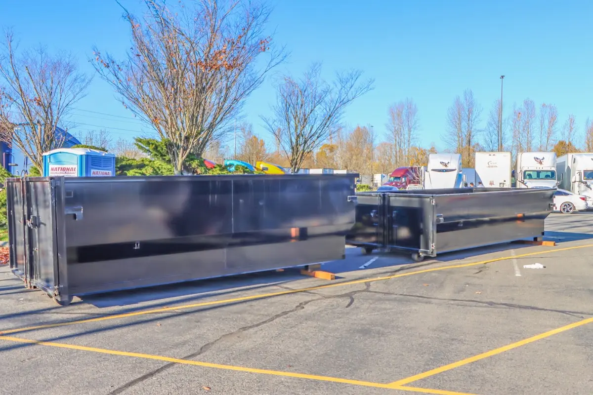 Professional dumpster rental service with roll-off container on residential driveway in Pittsford